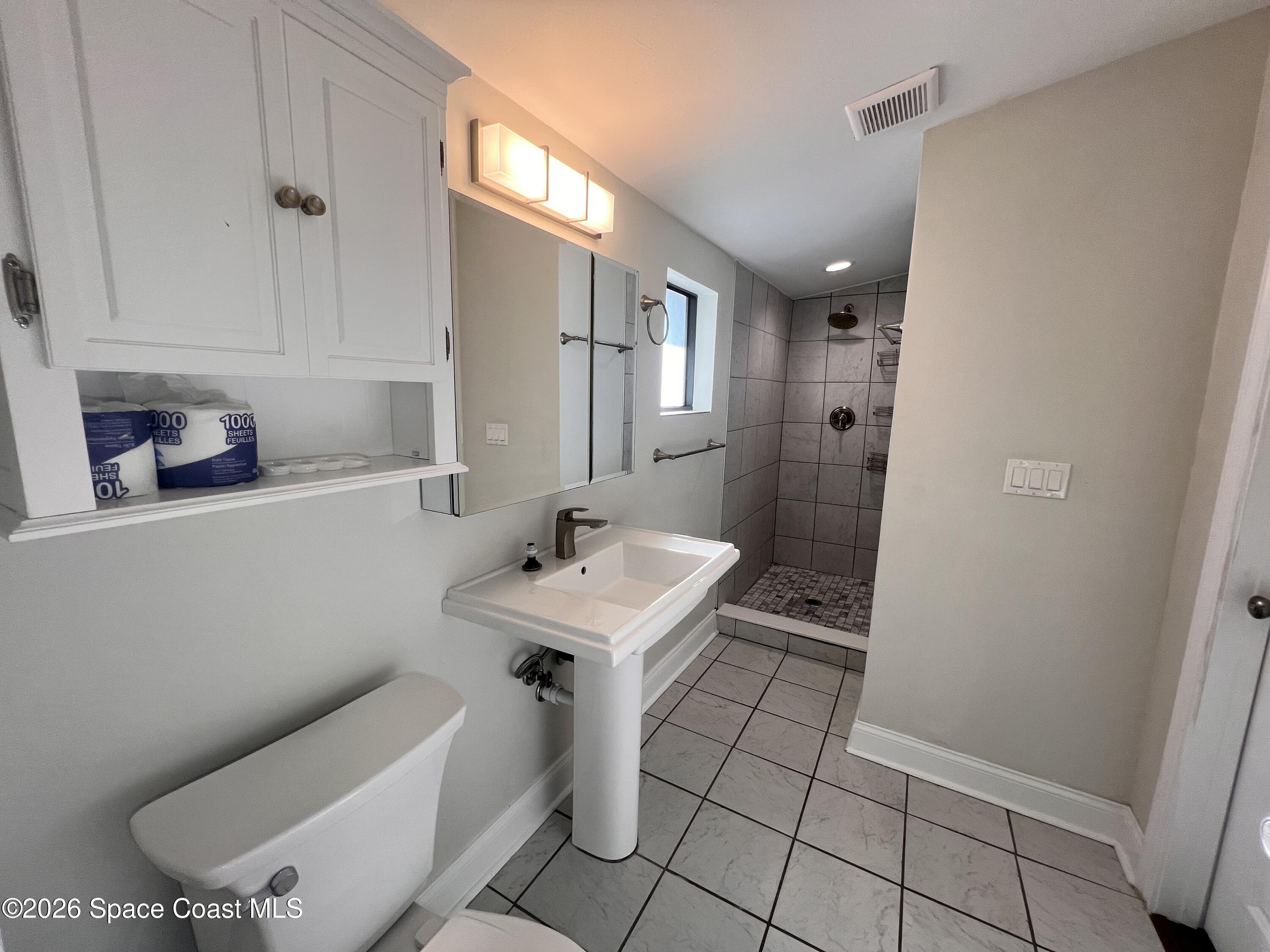 1935 Oak Street Melbourne, FL 32901 - Photo 11 of 13 a bathroom with a sink a toilet and mirror