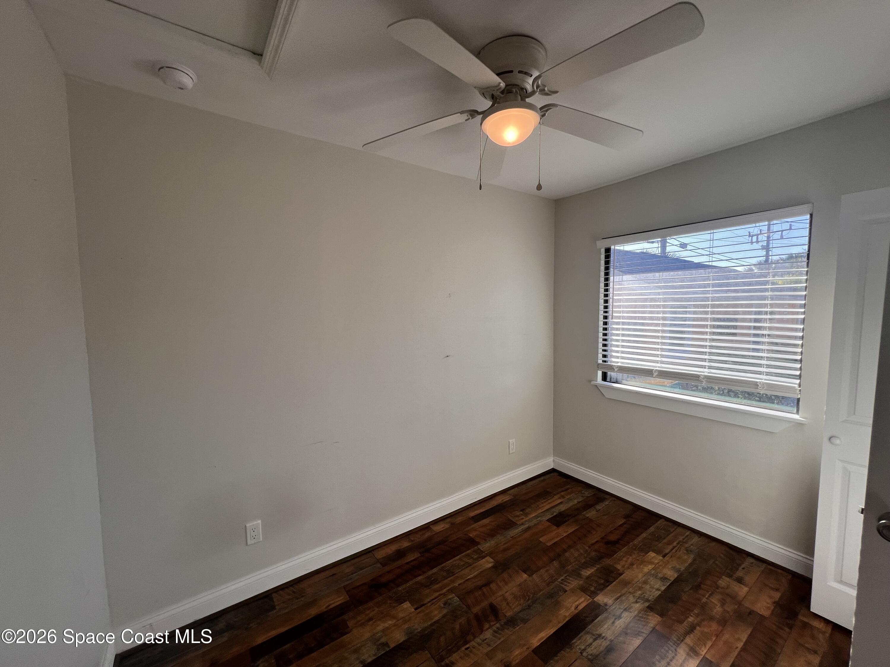 1935 Oak Street Melbourne, FL 32901 - Photo 2 of 13 an empty room with wooden floor and windows