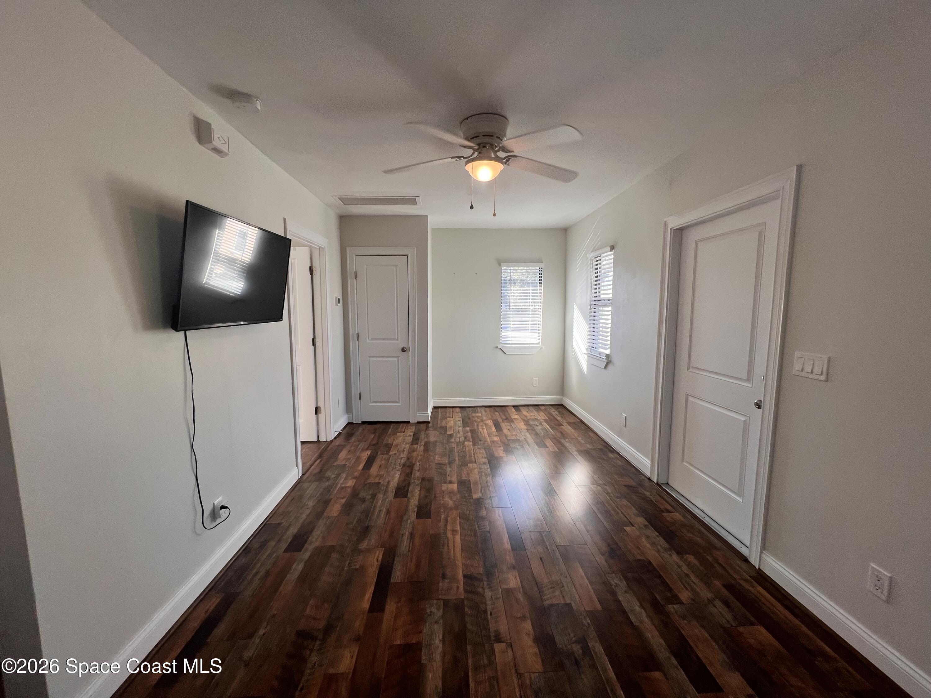 1935 Oak Street Melbourne, FL 32901 - Photo 5 of 13 wooden floor in an empty room with a window