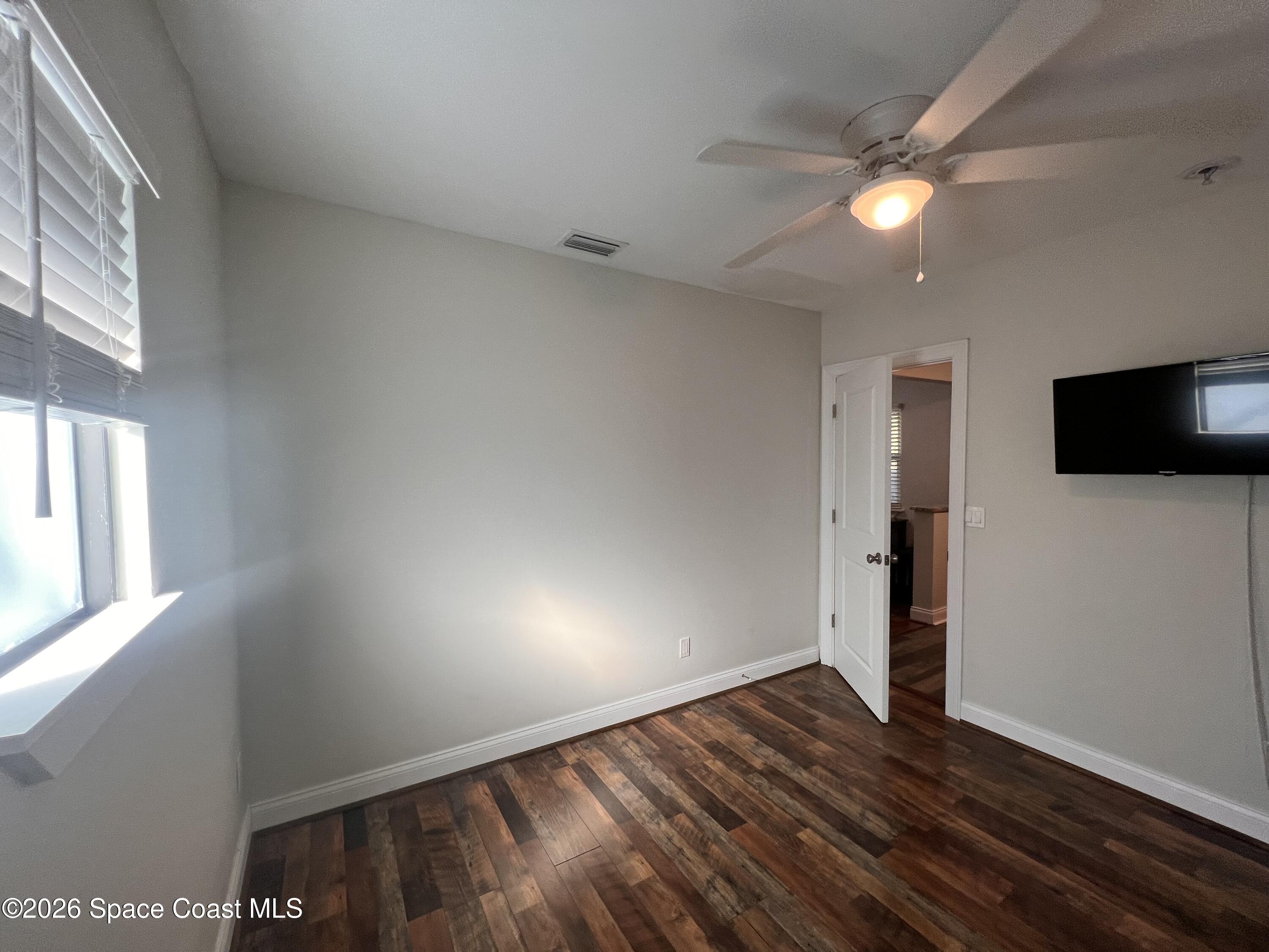 1935 Oak Street Melbourne, FL 32901 - Photo 9 of 13 a view of empty room with wooden floor and fan