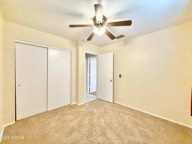 a view of a room with a ceiling fan