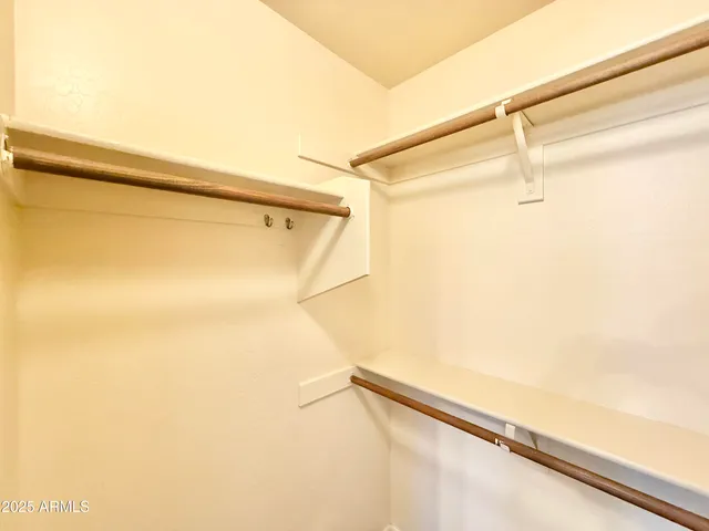 a view of closet and wooden floor