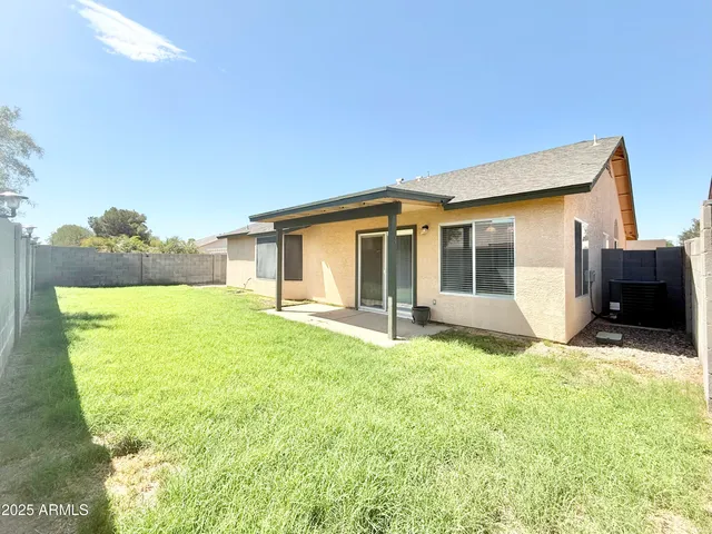 a backyard of a house with yard and outdoor seating