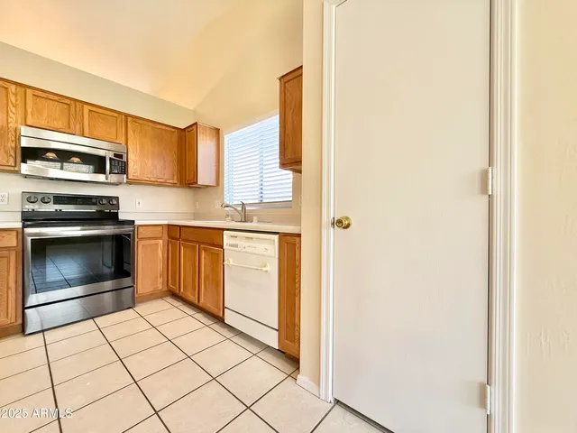 a kitchen with stainless steel appliances a stove top oven and a refrigerator