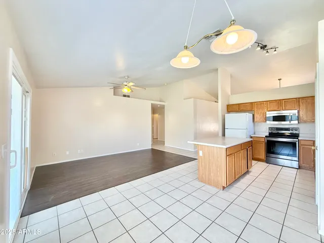 a kitchen with granite countertop a sink and cabinets