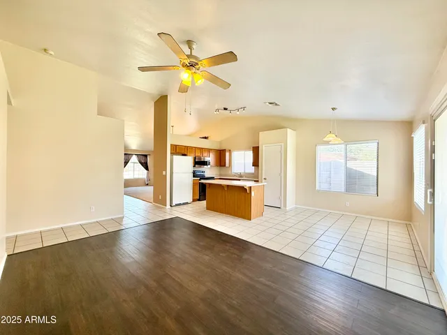 a view of a kitchen with wooden floor and a window