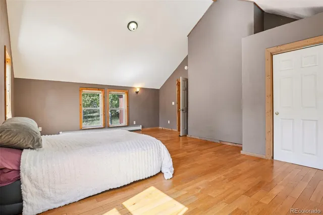 a bedroom with a large bed and a window