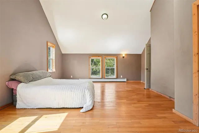 a bedroom with a large bed and a large window