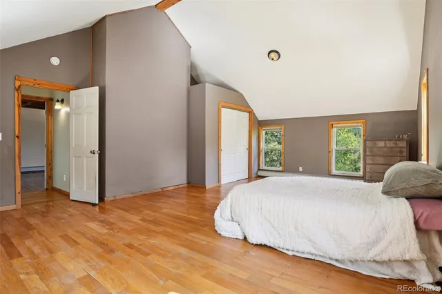 a bedroom with a large bed and a large window