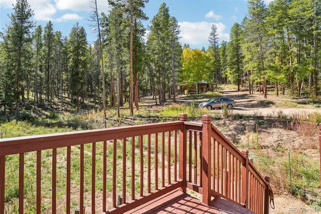 a view of a balcony with trees