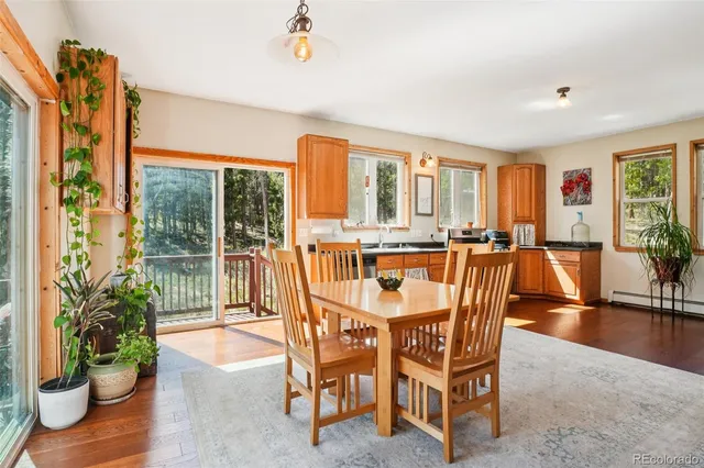 a dining room with furniture and wooden floor