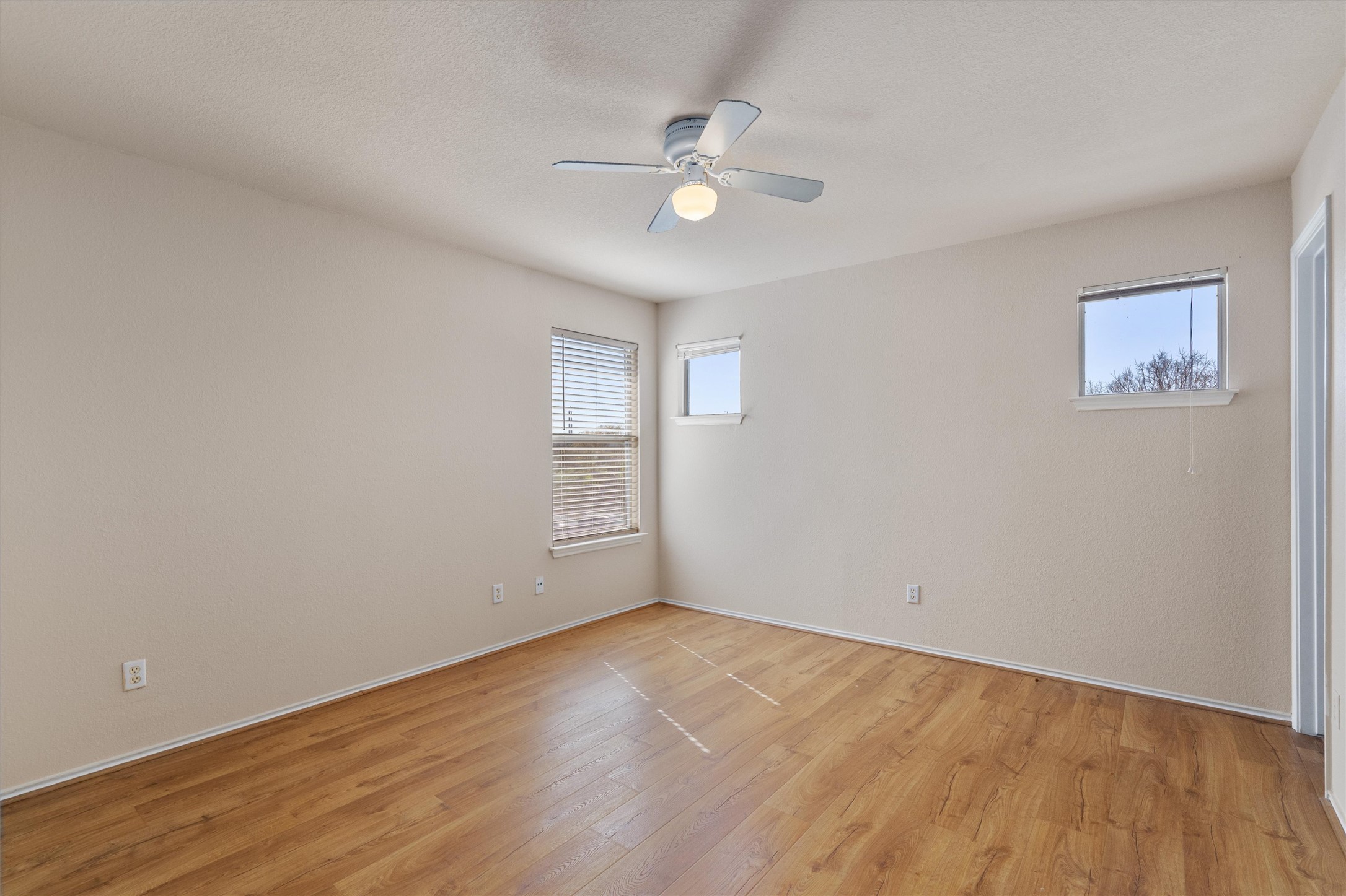13720 Harris Ridge Boulevard, Unit A Pflugerville, TX 78660 - Photo 13 of 27 Spare room with light wood-style flooring and ceiling fan