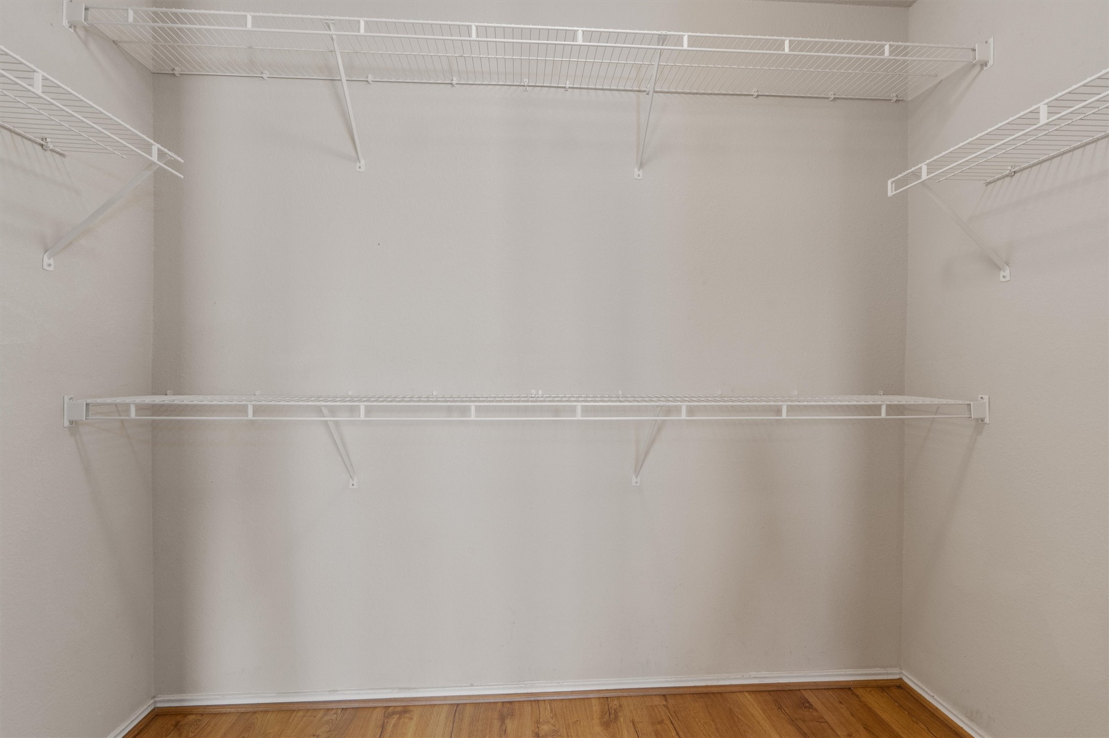 13720 Harris Ridge Boulevard, Unit A Pflugerville, TX 78660 - Photo 17 of 27 Walk in closet featuring light wood-style flooring