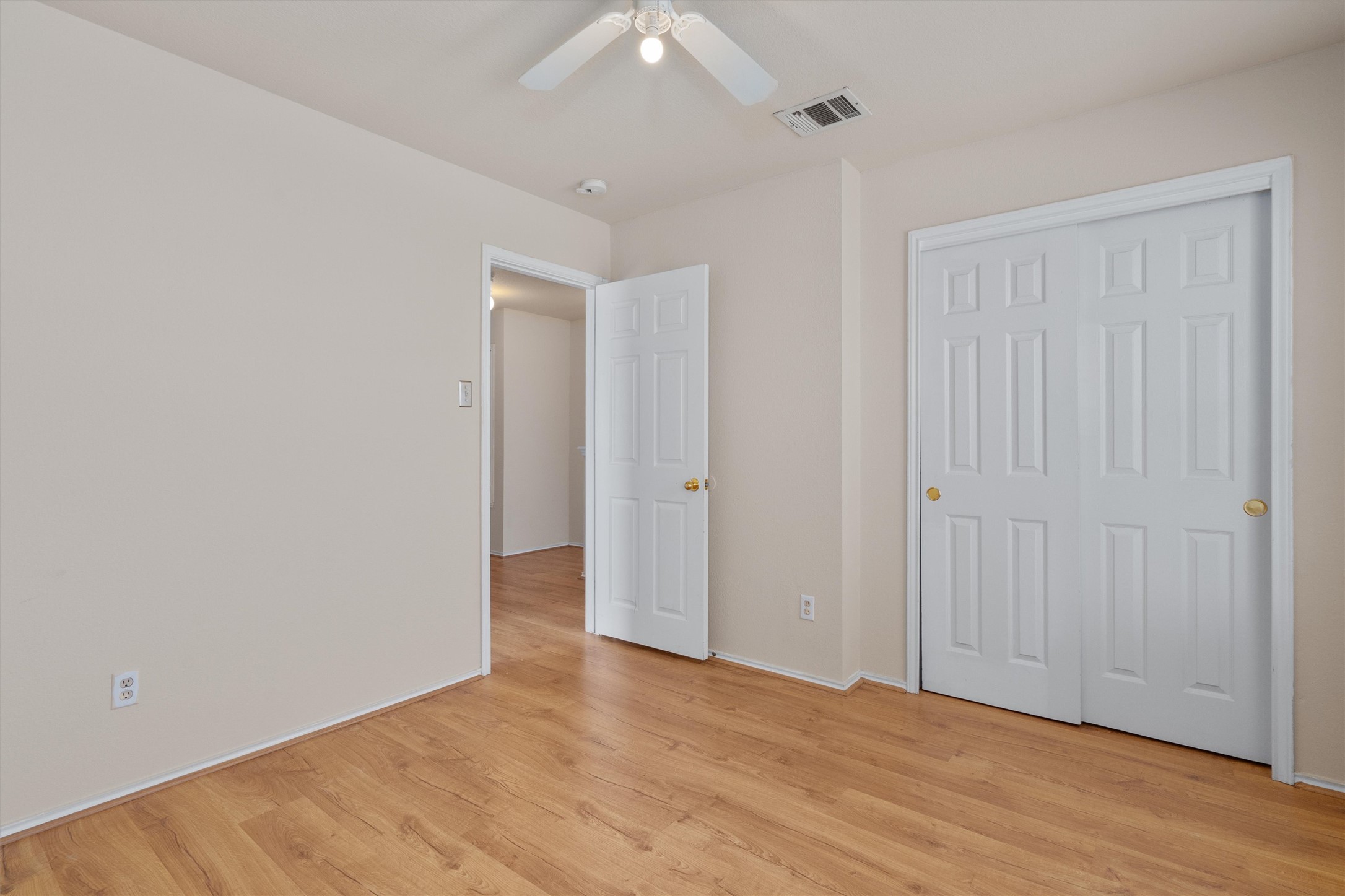 13720 Harris Ridge Boulevard, Unit A Pflugerville, TX 78660 - Photo 19 of 27 Unfurnished bedroom with light wood-style flooring and a ceiling fan