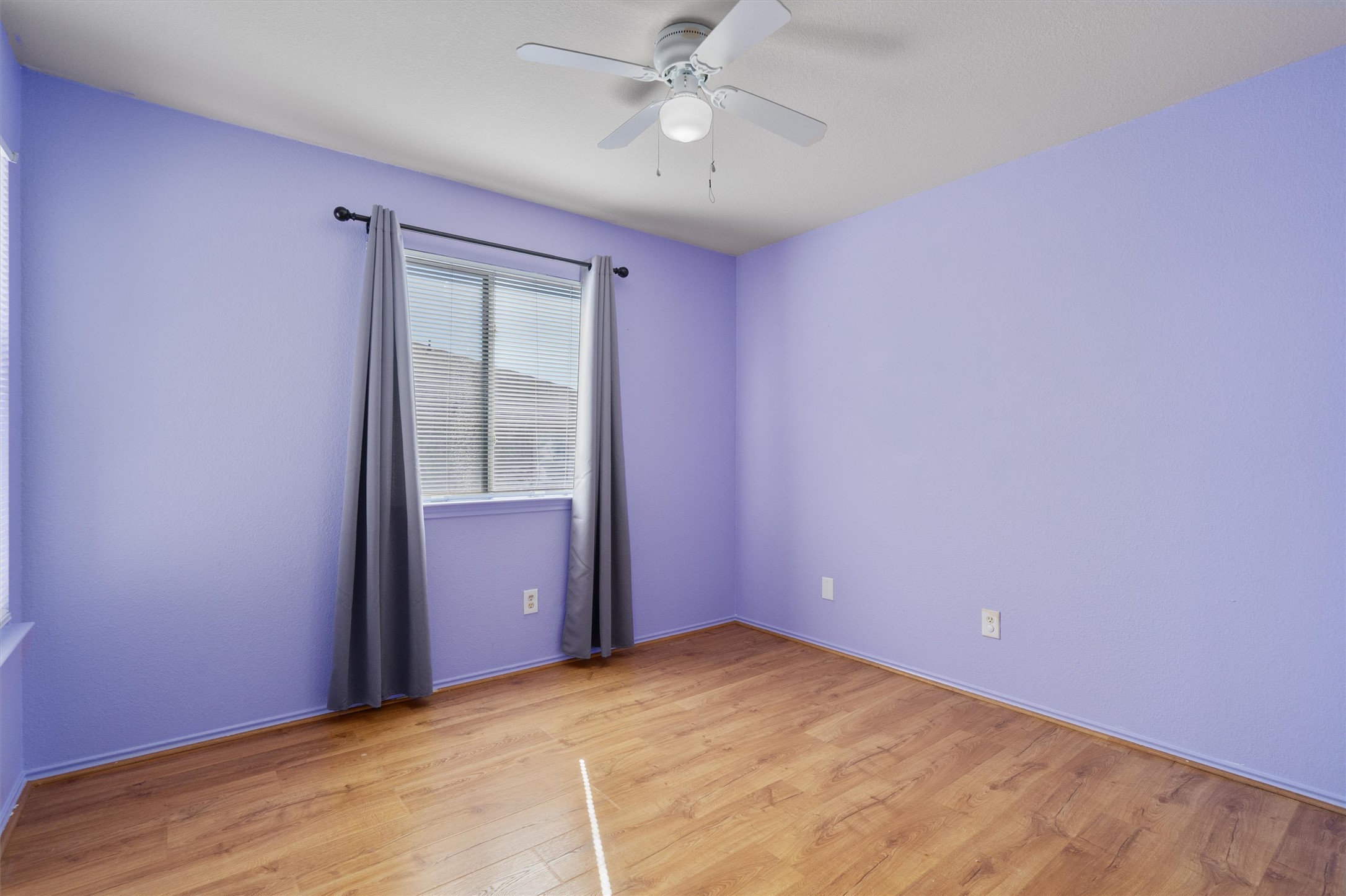 13720 Harris Ridge Boulevard, Unit A Pflugerville, TX 78660 - Photo 20 of 27 Empty room featuring light wood finished floors and a ceiling fan