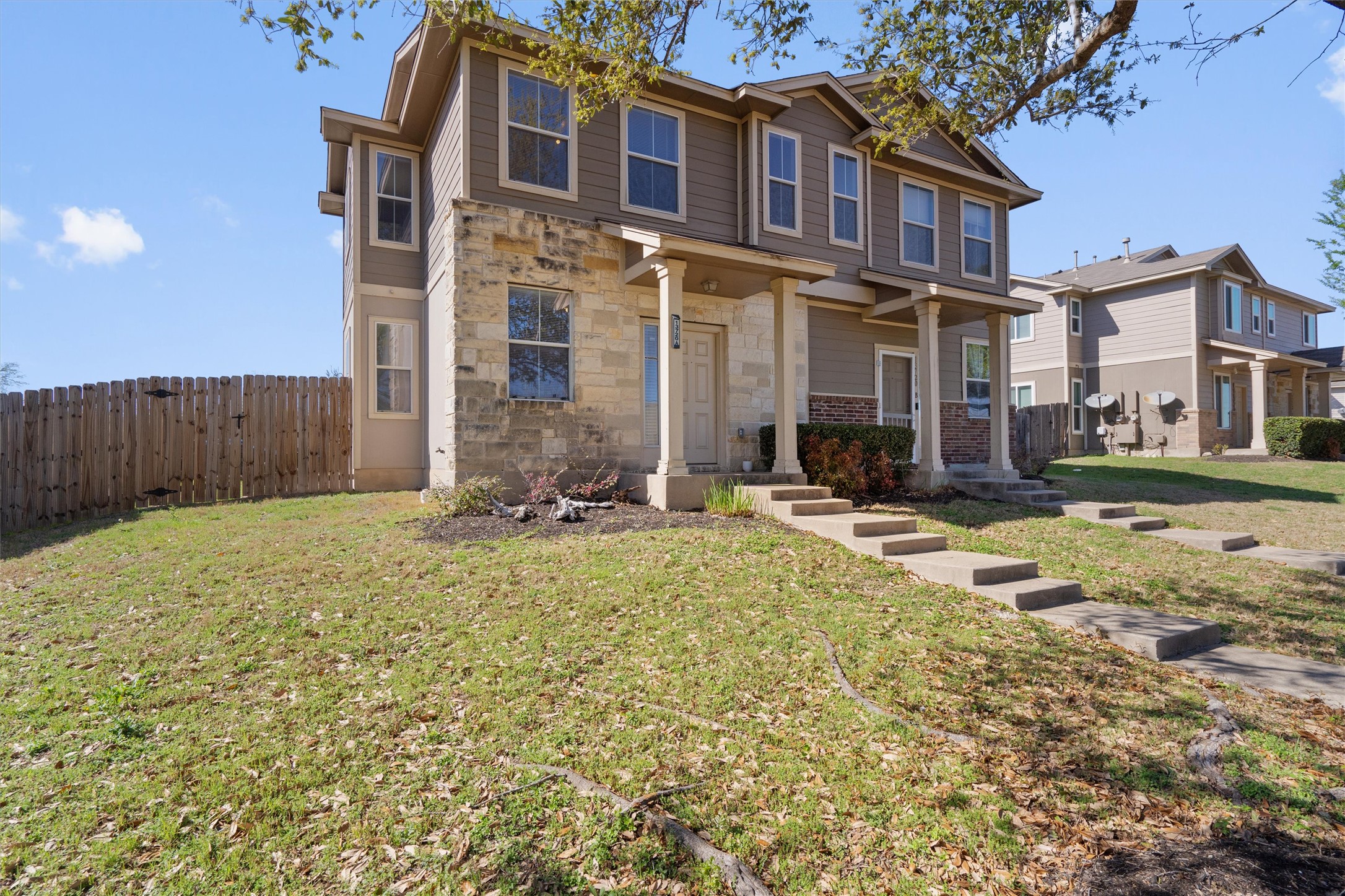 13720 Harris Ridge Boulevard, Unit A Pflugerville, TX 78660 - Photo 2 of 27 View of front facade with a porch and stone siding