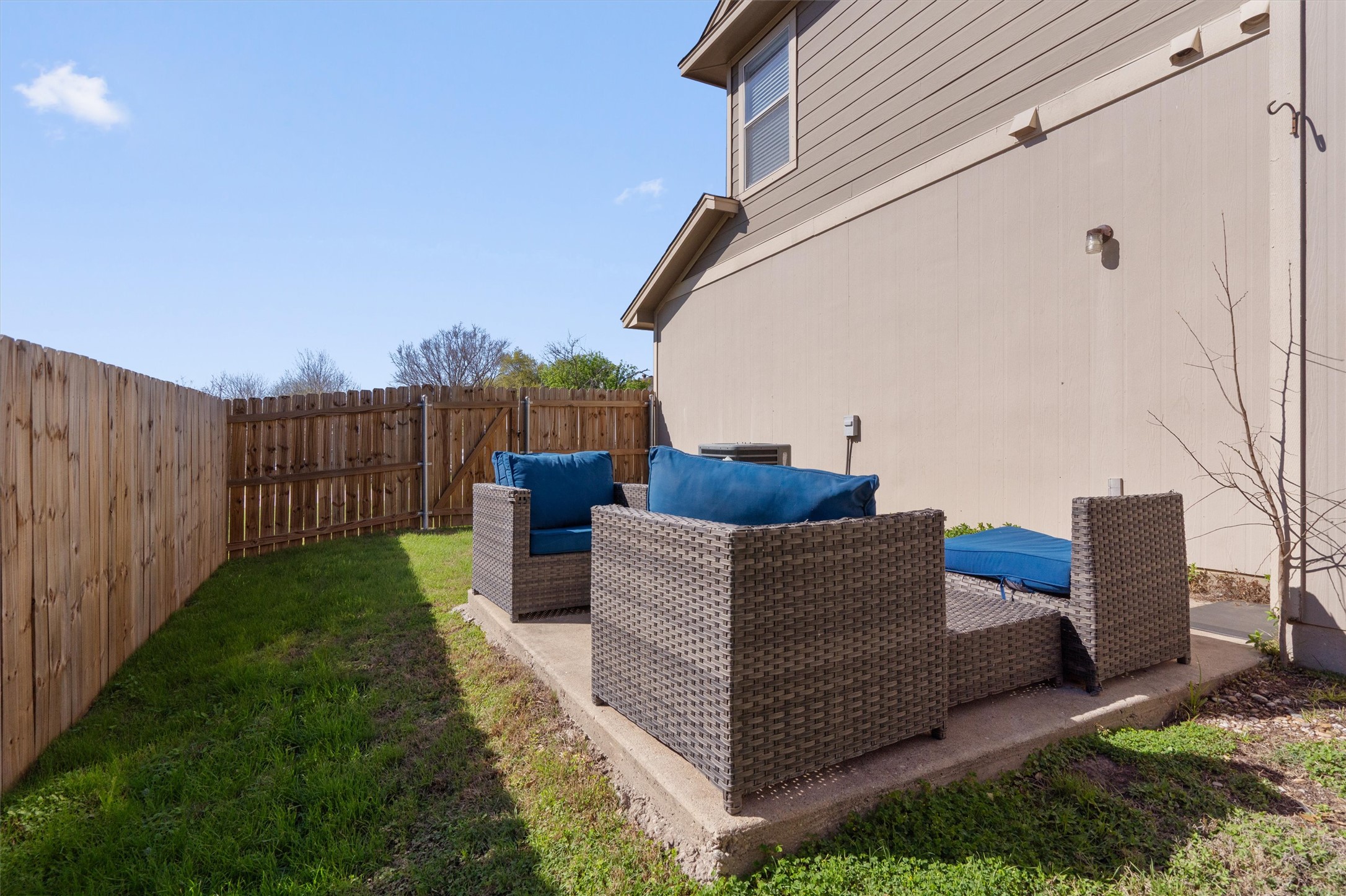 13720 Harris Ridge Boulevard, Unit A Pflugerville, TX 78660 - Photo 23 of 27 View of home's exterior with a fenced backyard, outdoor seating, and a patio area