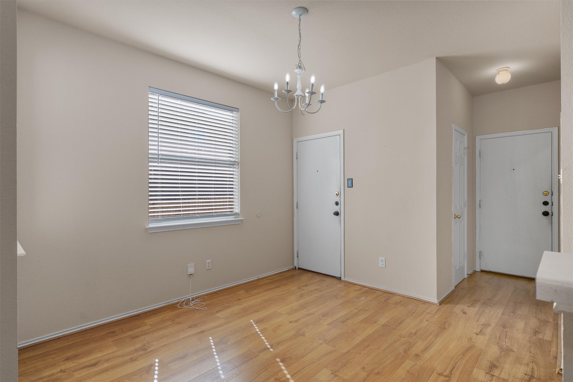 13720 Harris Ridge Boulevard, Unit A Pflugerville, TX 78660 - Photo 6 of 27 Entryway featuring suspended lighting and light wood-type flooring