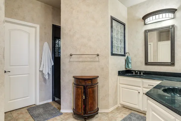 a kitchen with granite countertop a sink and a stove top oven