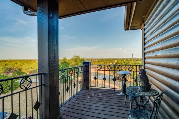 a view of a balcony with chairs