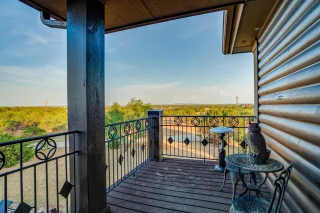 a view of a balcony with chairs