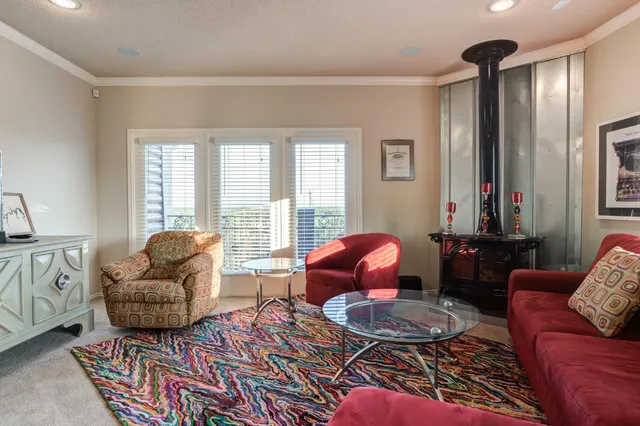 a living room with furniture and a floor to ceiling window