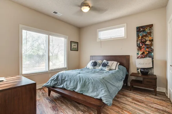 a bedroom with a bed and a window