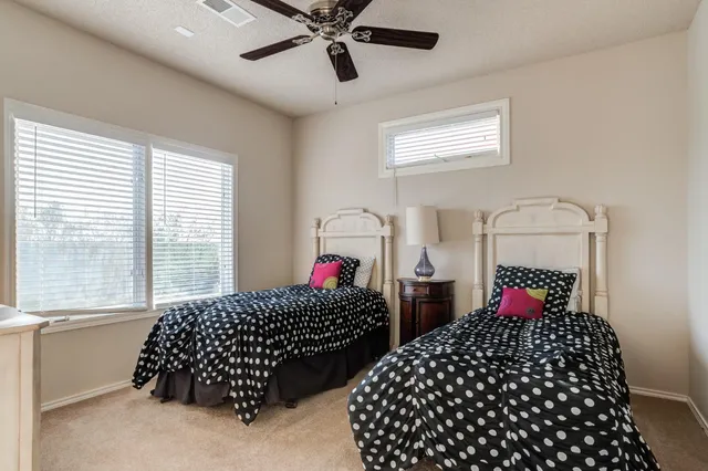a bedroom with two beds and a window