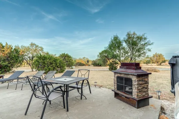 a view of a chairs and table in the patio