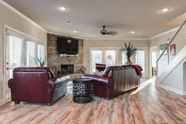 a living room with furniture a flat screen tv and a fireplace