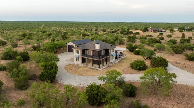 a view of a lake with a table and chairs