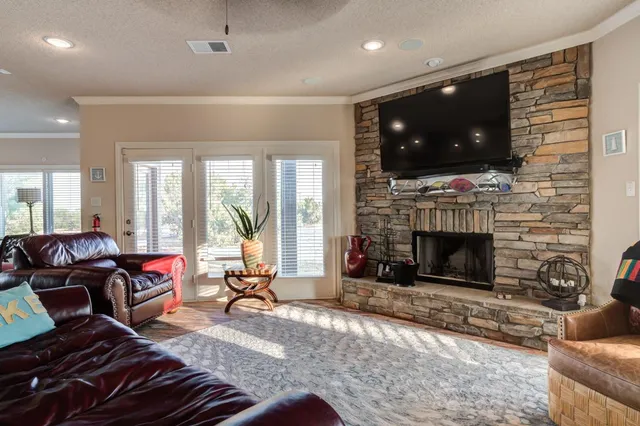 a living room with furniture a flat screen tv and a fireplace