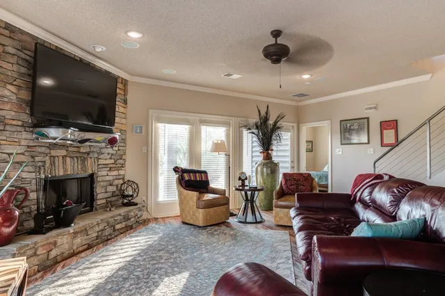 a living room with furniture a flat screen tv and a fireplace