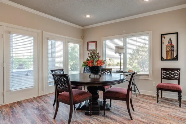 a view of a a dining room with furniture window and wooden floor