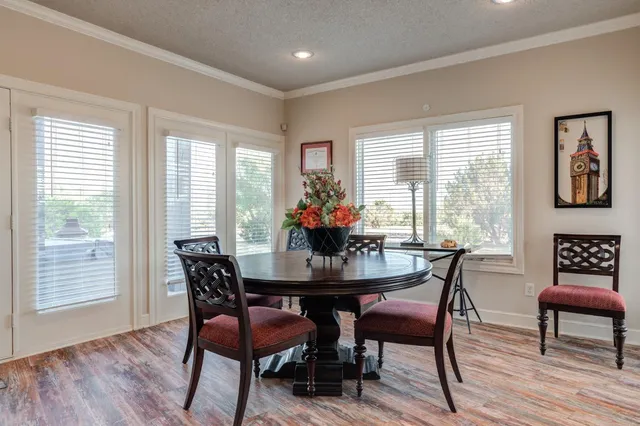 a view of a a dining room with furniture window and wooden floor