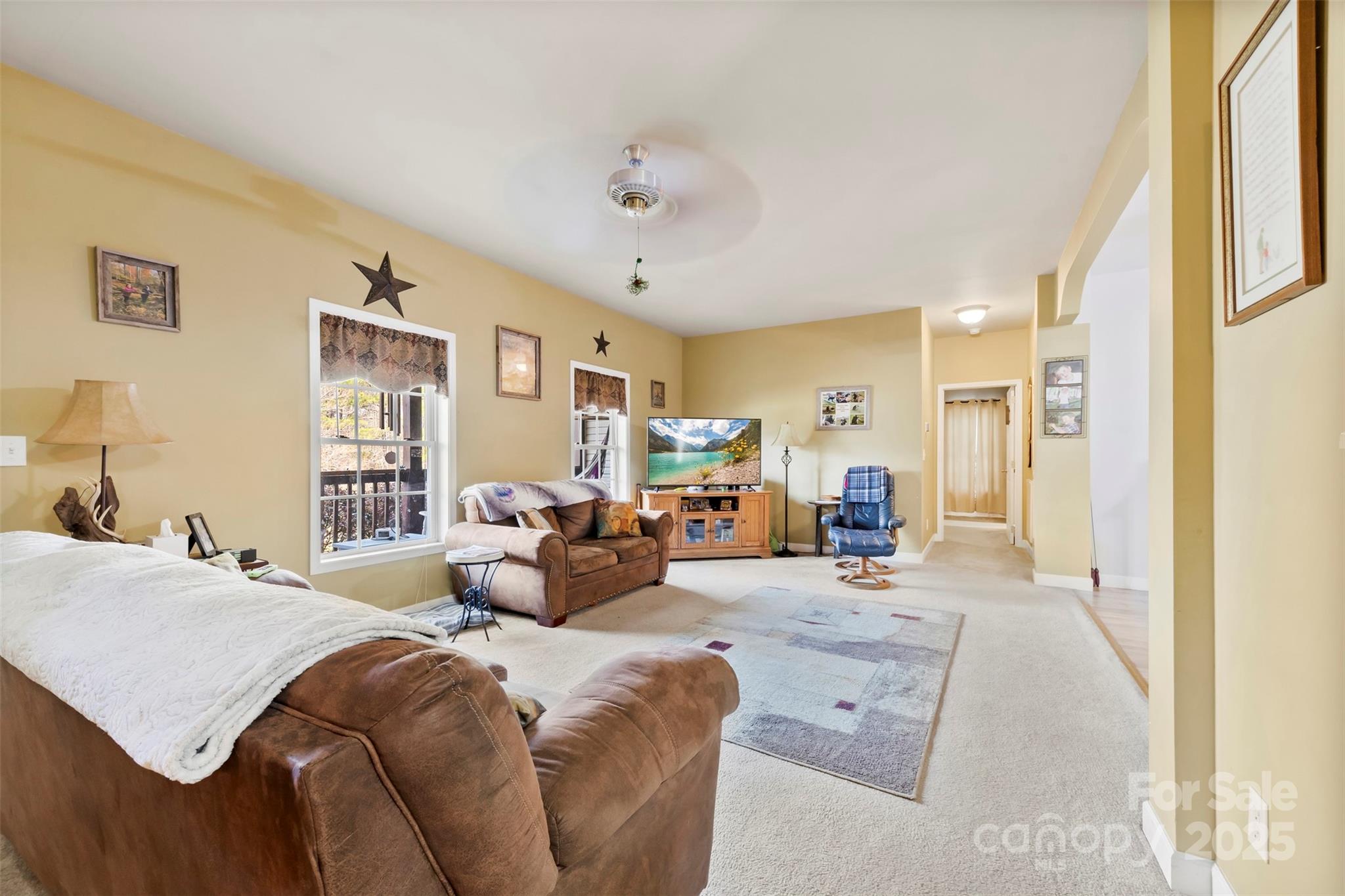 1581 Rhyne Road Dallas, NC 28034 - Photo 9 of 25 a bedroom with a large bed and a chandelier