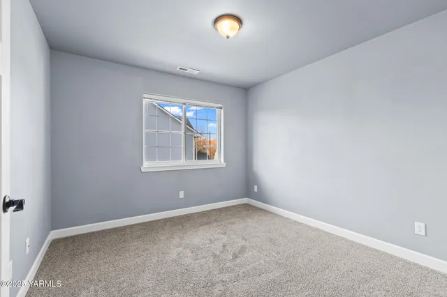 an empty room with windows and view