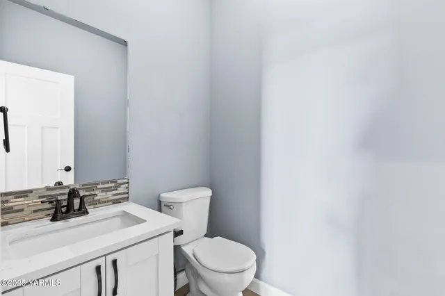 a bathroom with a sink a toilet and mirror