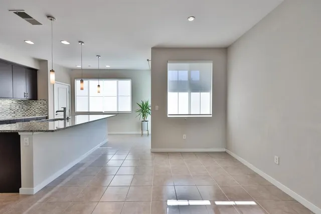 a view of a kitchen with a sink and a window