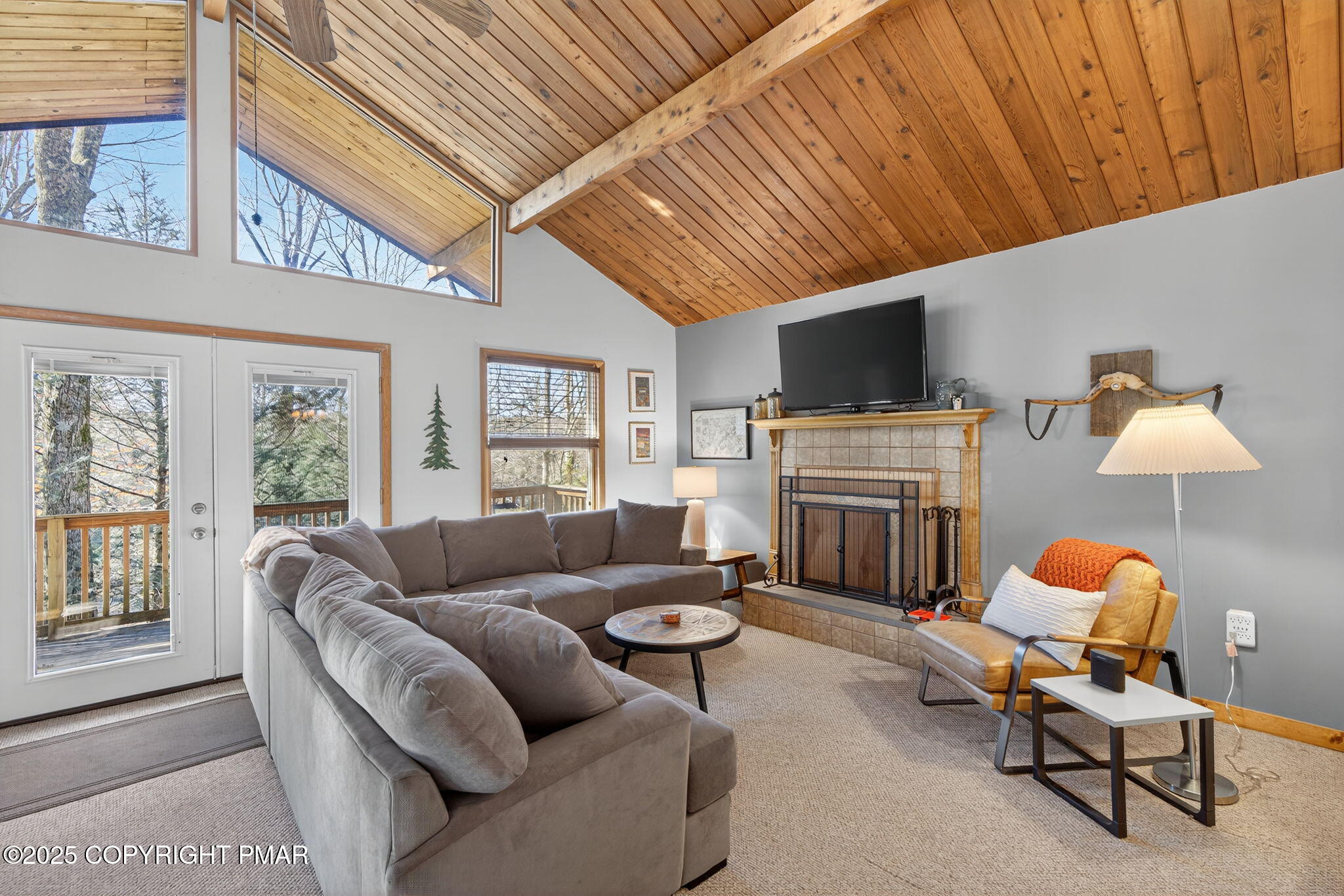 134 Deerfield Road Lake Ariel, PA 18436 - Photo 26 of 56 a living room with furniture a fireplace and a flat screen tv