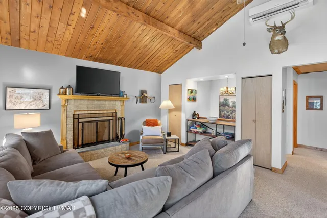a living room with furniture a flat screen tv and a window