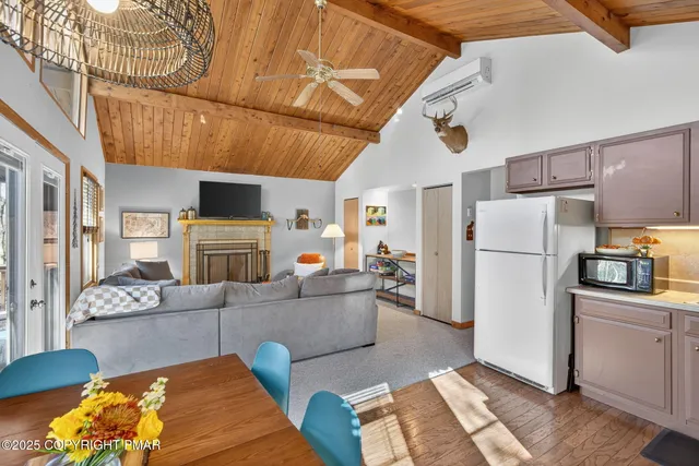 a living room with furniture and a baby crib