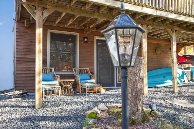 a backyard of a house with barbeque oven table and chairs