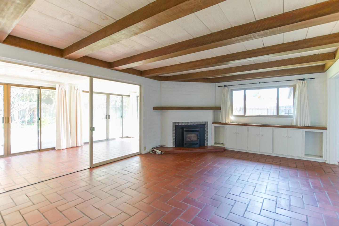 1521 Cienega Road Hollister, CA 95023 - Photo 19 of 56 a view of an empty room with a fireplace and a window