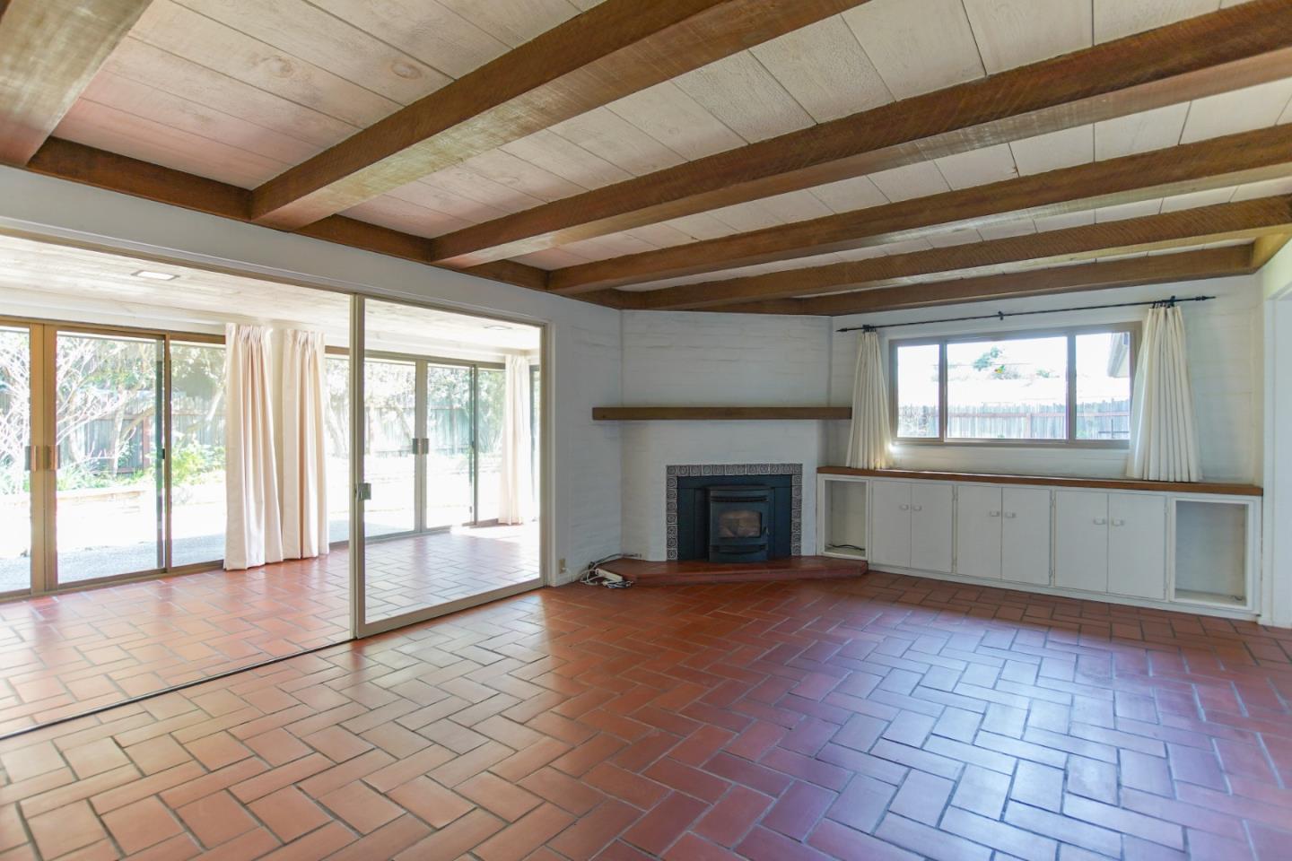 1521 Cienega Road Hollister, CA 95023 - Photo 20 of 56 a view of an empty room with a fireplace and a window