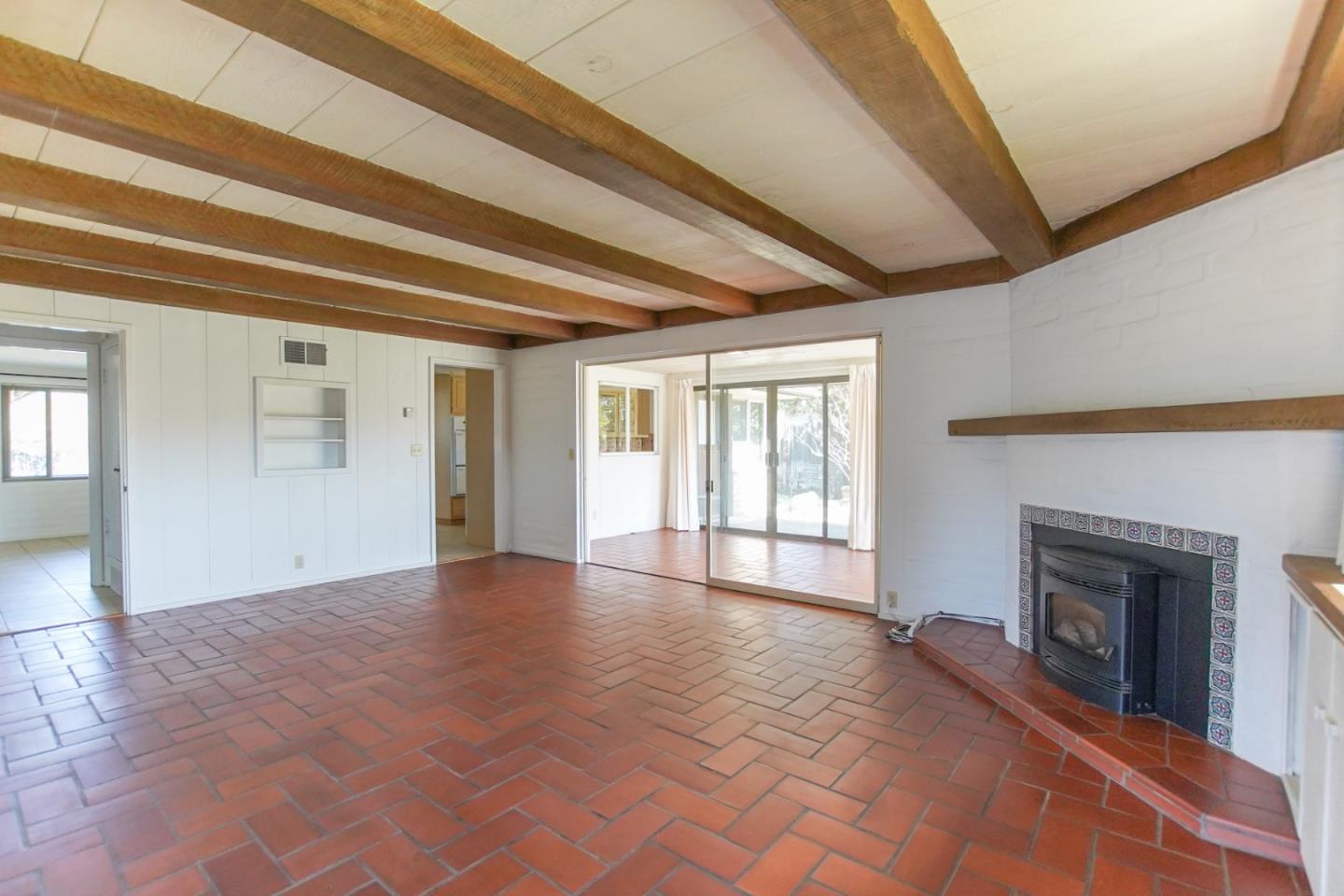 1521 Cienega Road Hollister, CA 95023 - Photo 21 of 56 a view of an empty room with a fireplace and a window