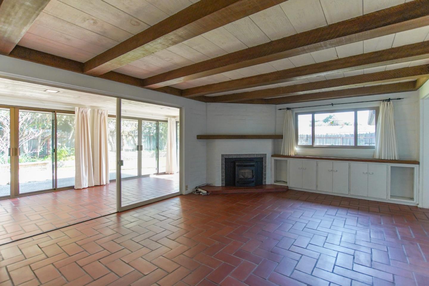 1521 Cienega Road Hollister, CA 95023 - Photo 25 of 56 a view of an empty room with a fireplace and a window