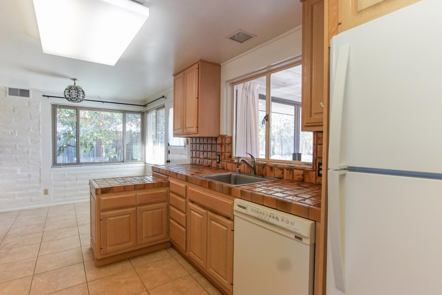 1521 Cienega Road Hollister, CA 95023 - Photo 34 of 56 a kitchen with a sink stove and cabinets