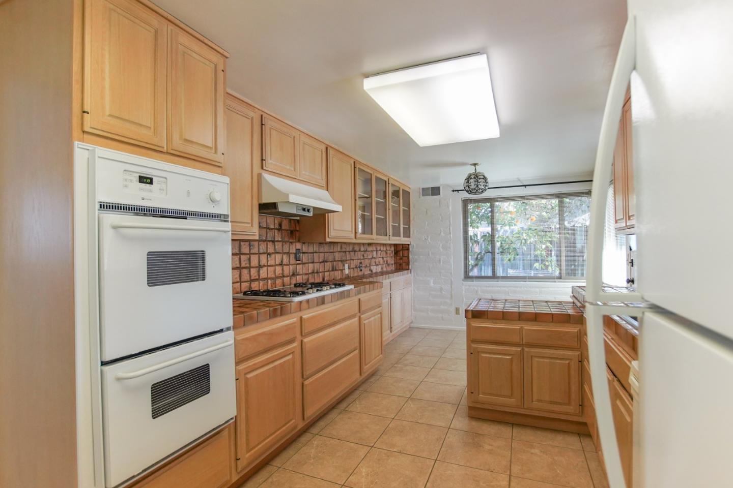 1521 Cienega Road Hollister, CA 95023 - Photo 36 of 56 a kitchen with stainless steel appliances granite countertop a refrigerator and a stove top oven