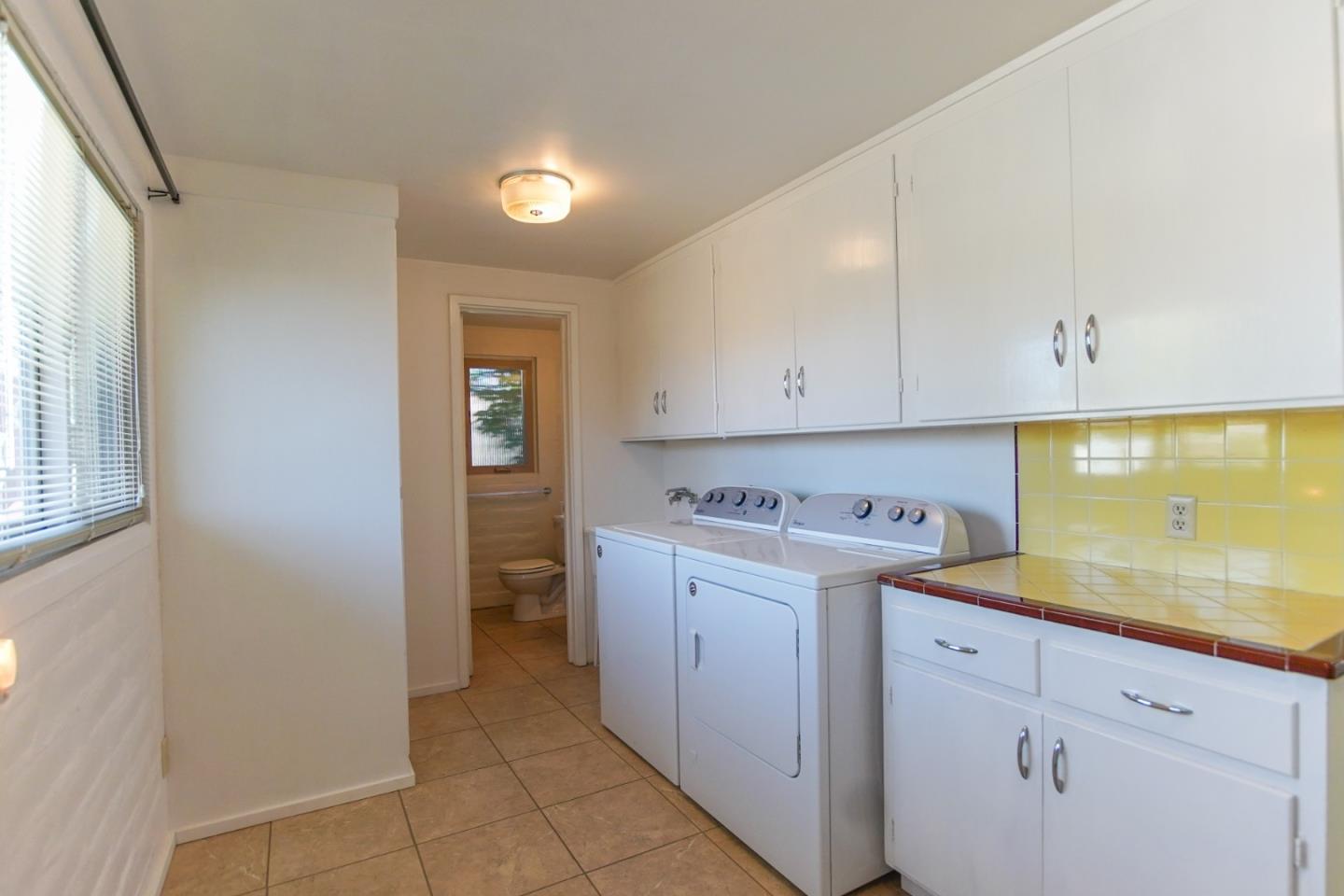 1521 Cienega Road Hollister, CA 95023 - Photo 38 of 56 a utility room with cabinets washer and dryer